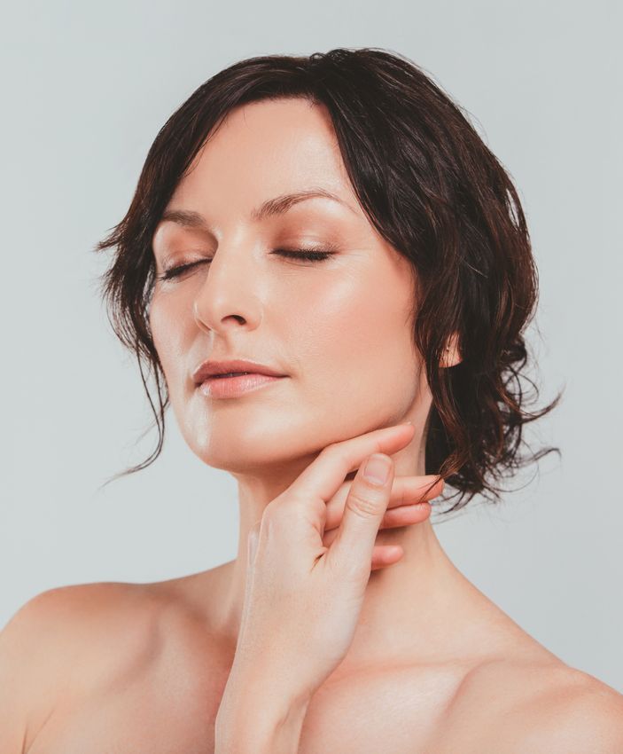 Crown Point Photofacial model with eyes closed touching her chin